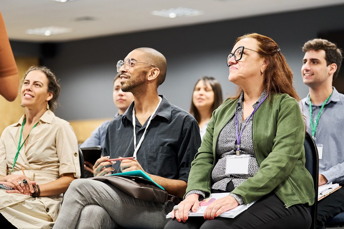 men and women attending a conference engaged with speaker